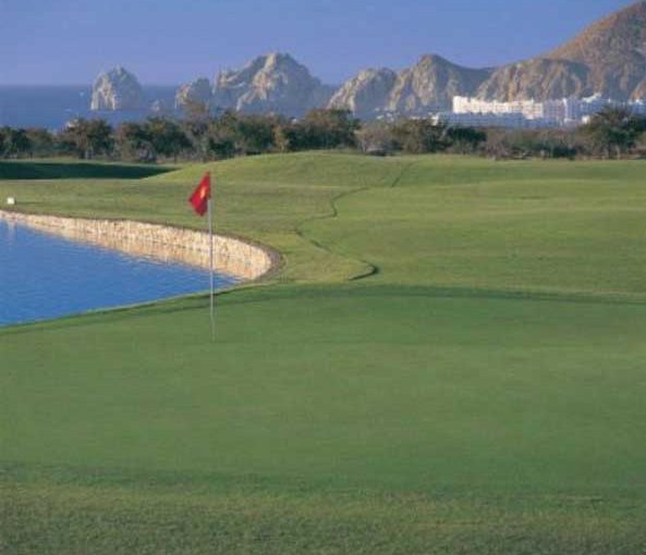 Pedregal Golf Course In Los Cabos With Lush Green Fairways, Rocky Hills, And Ocean Backdrop
