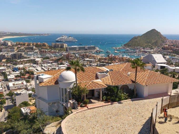 Luxurious Pedregal Ocean View Home With Terracotta Roof Tiles Overlooking The Puerto Vallarta Marina And Mountain Landscape, Featuring Pristine Architecture And Breathtaking Waterfront Scenery.