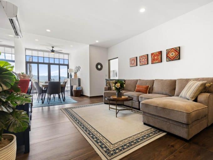 Spacious Pedregal Living Room With Modern Decor, Large Windows With Mountain Views, And Hardwood Floors, Perfect For Comfortable Living And Entertaining.