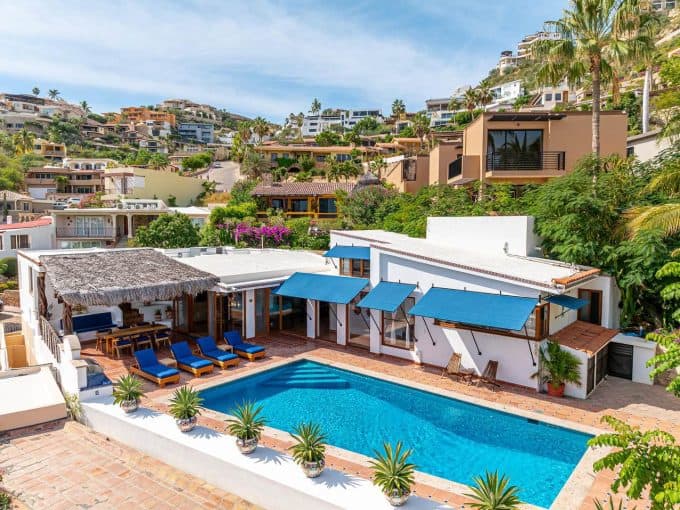 1. A Lush Hillside View Of Pedregal Real Estate With Modern Homes, Vibrant Greenery, And A Sparkling Pool In A Luxurious Neighborhood.