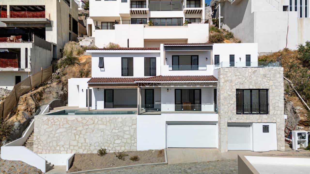 Luxurious Modern Pedregal Home Featuring White Stucco Walls, Stone Accents, Spacious Balconies, And Hillside City Views In Pedregal Real Estate Listings.