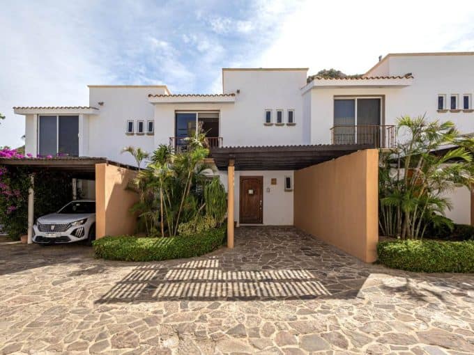 Luxurious Pedregal Condo With Lush Landscaping, Private Balconies, And A Stylish Driveway Featuring A Covered Parking Area, Perfect For Vibrant Island Living And Easy Access To Top Amenities.