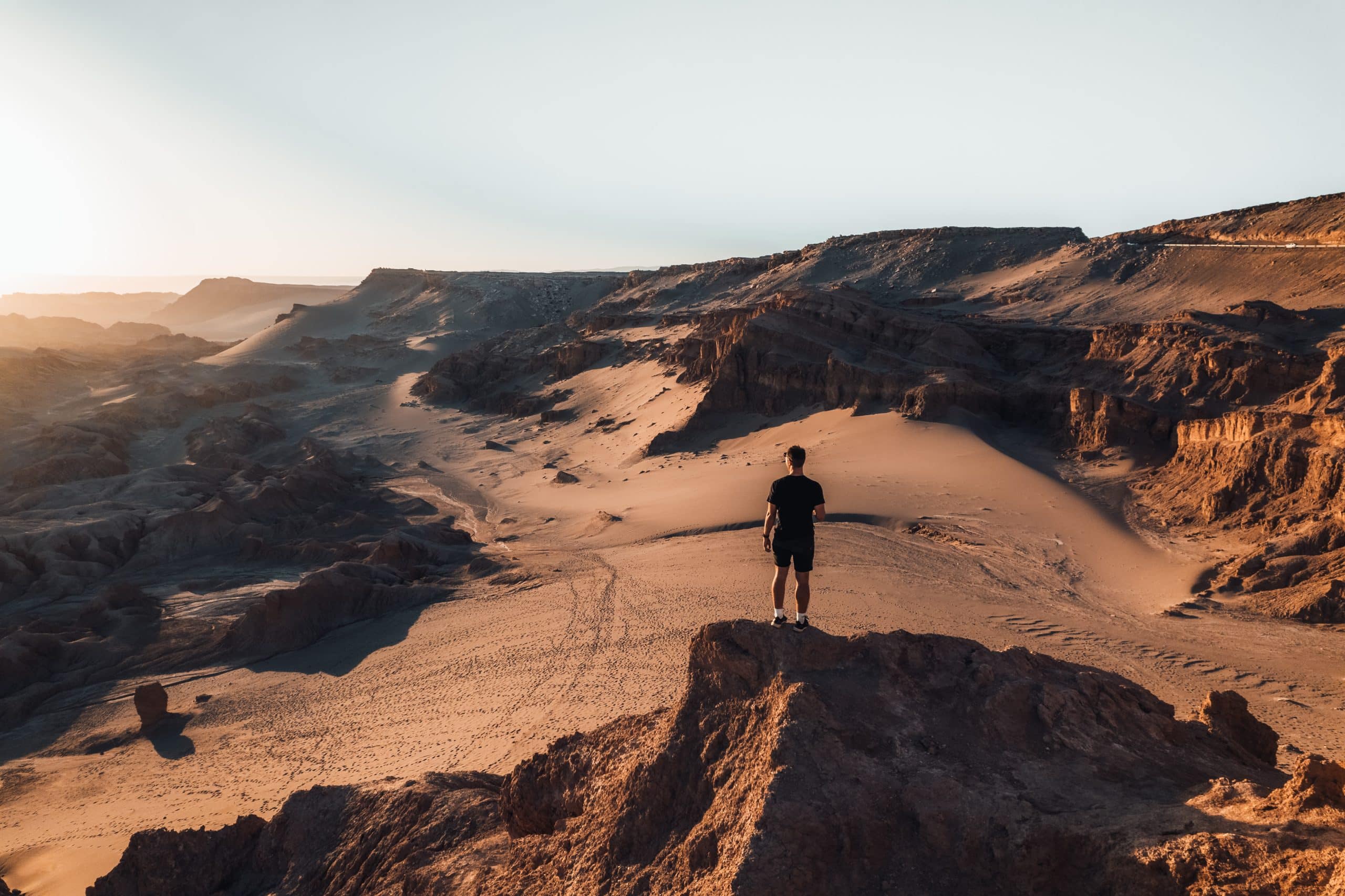 Man standing on top of rocks in the desert