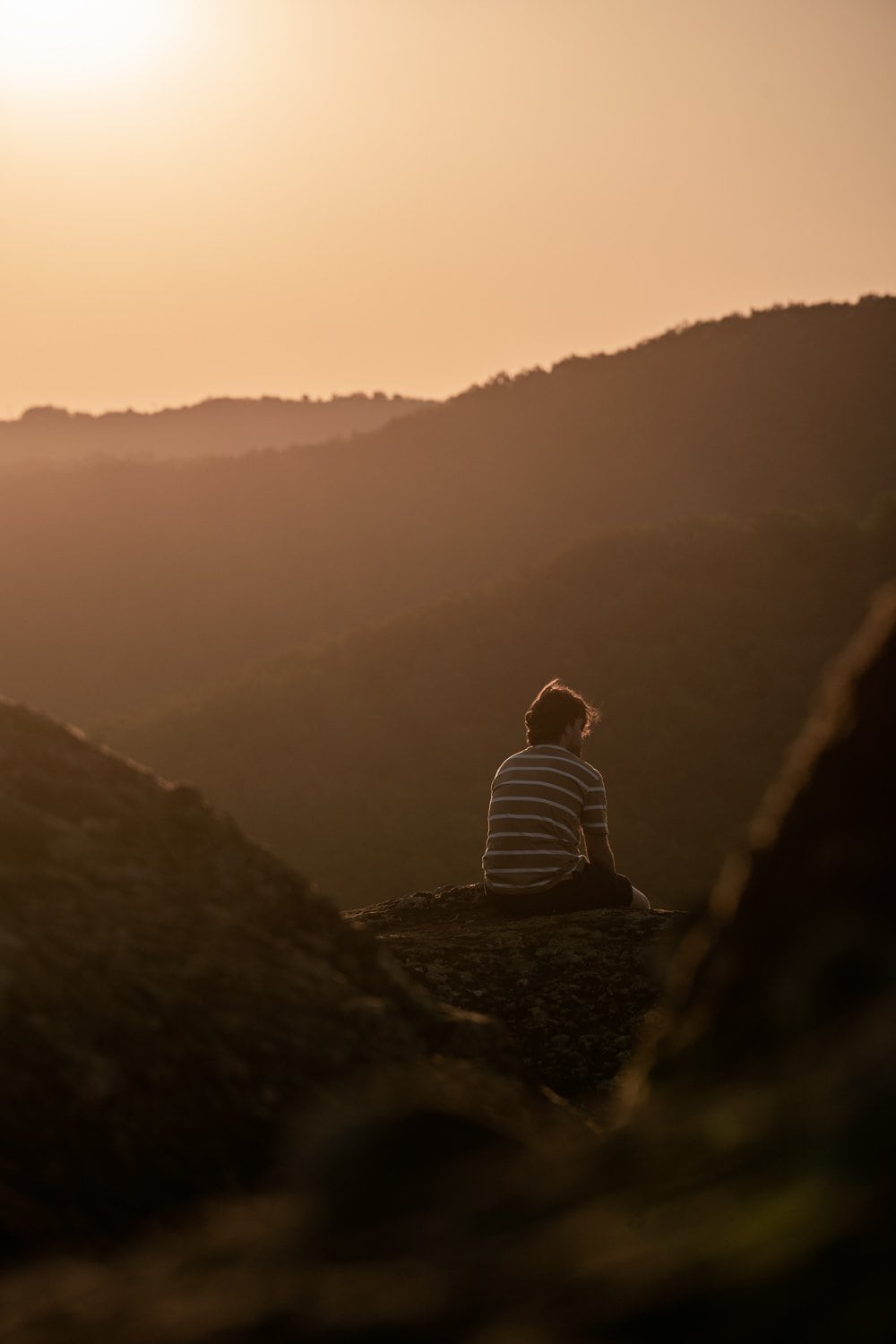 Man sitting down overlooking hill