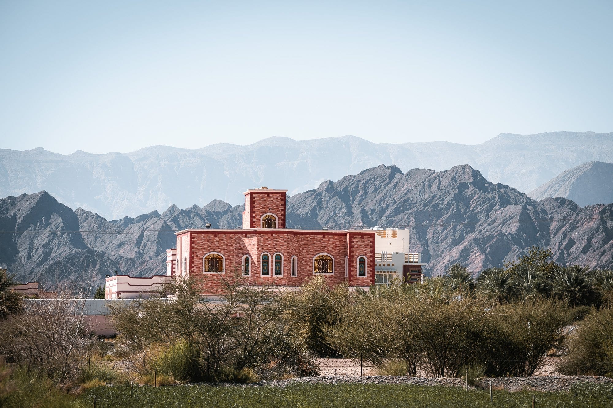 Traditional house in Oman with a stunning mountain backdrop