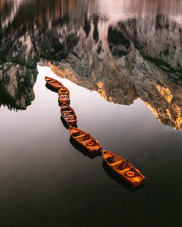boat on lake with mountain reflection