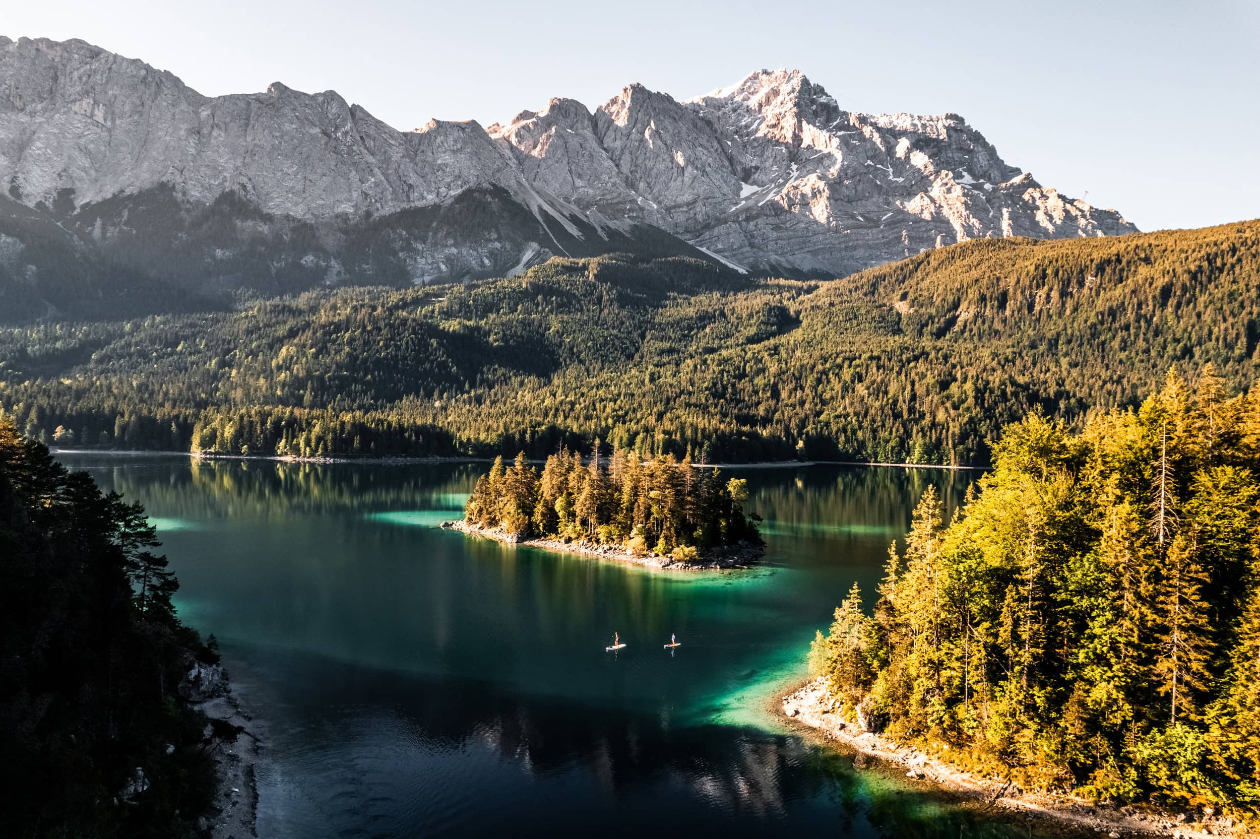 Mountain lake in Germany with turquoise coloured water, Zugspitze in the background and a forest in frame
