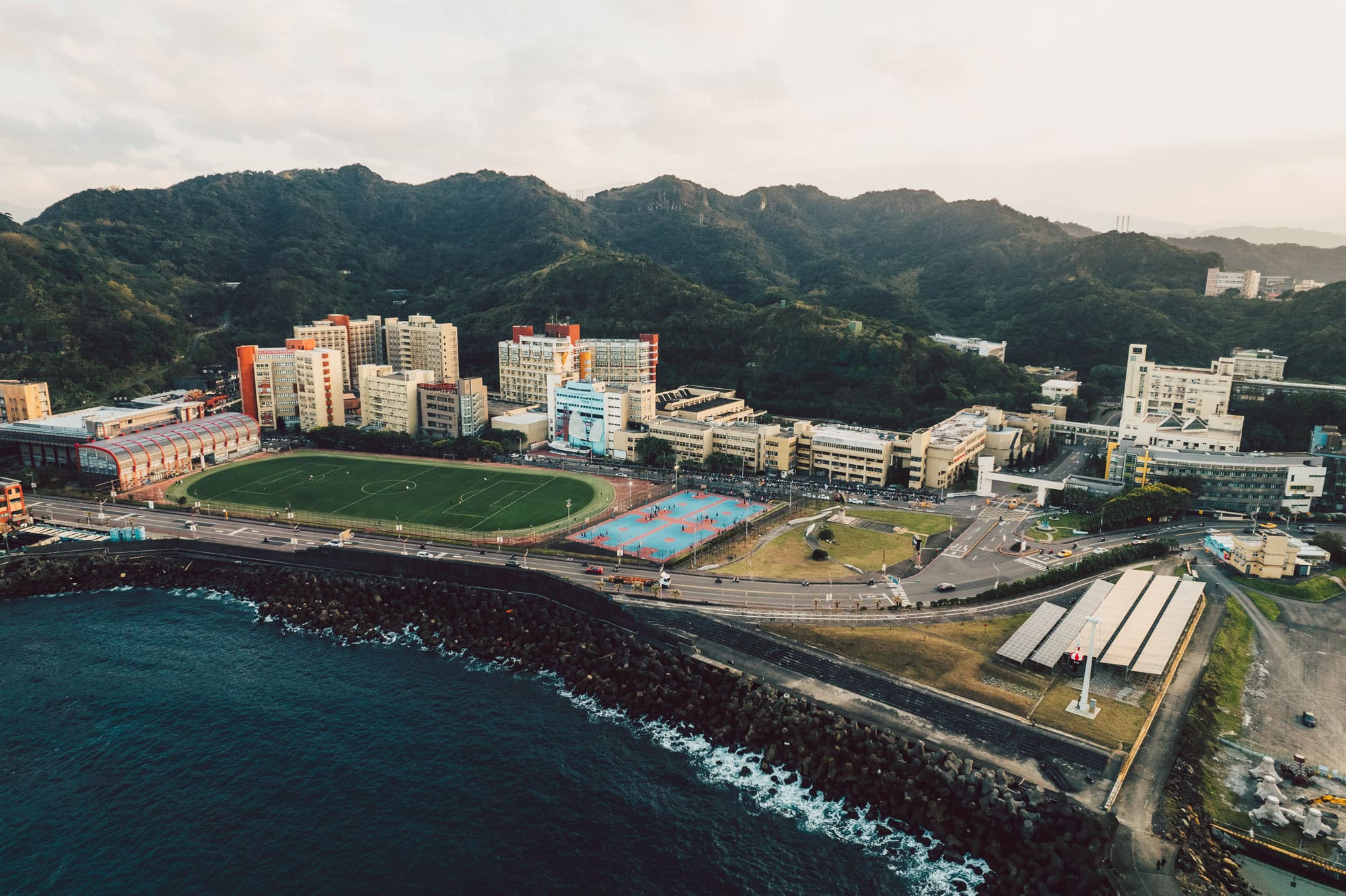 Aerial photo of Taiwan around Keelung with sea, city, sports and mountains.