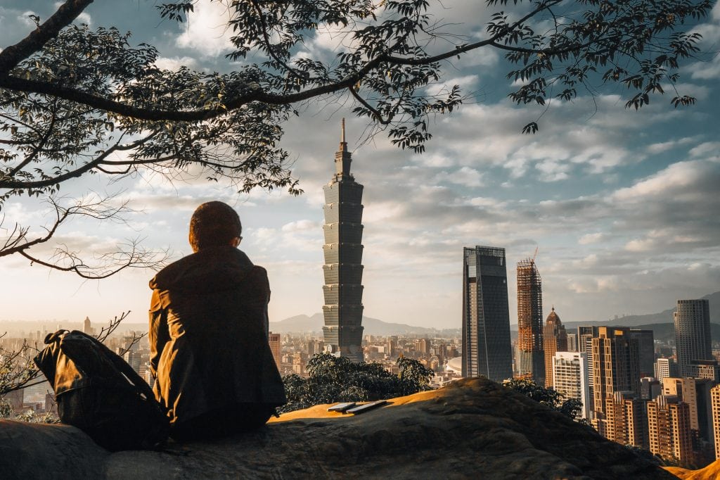 Elephant Mountain view in Taipei with a person in the foreground and Taipei 101 in the back.