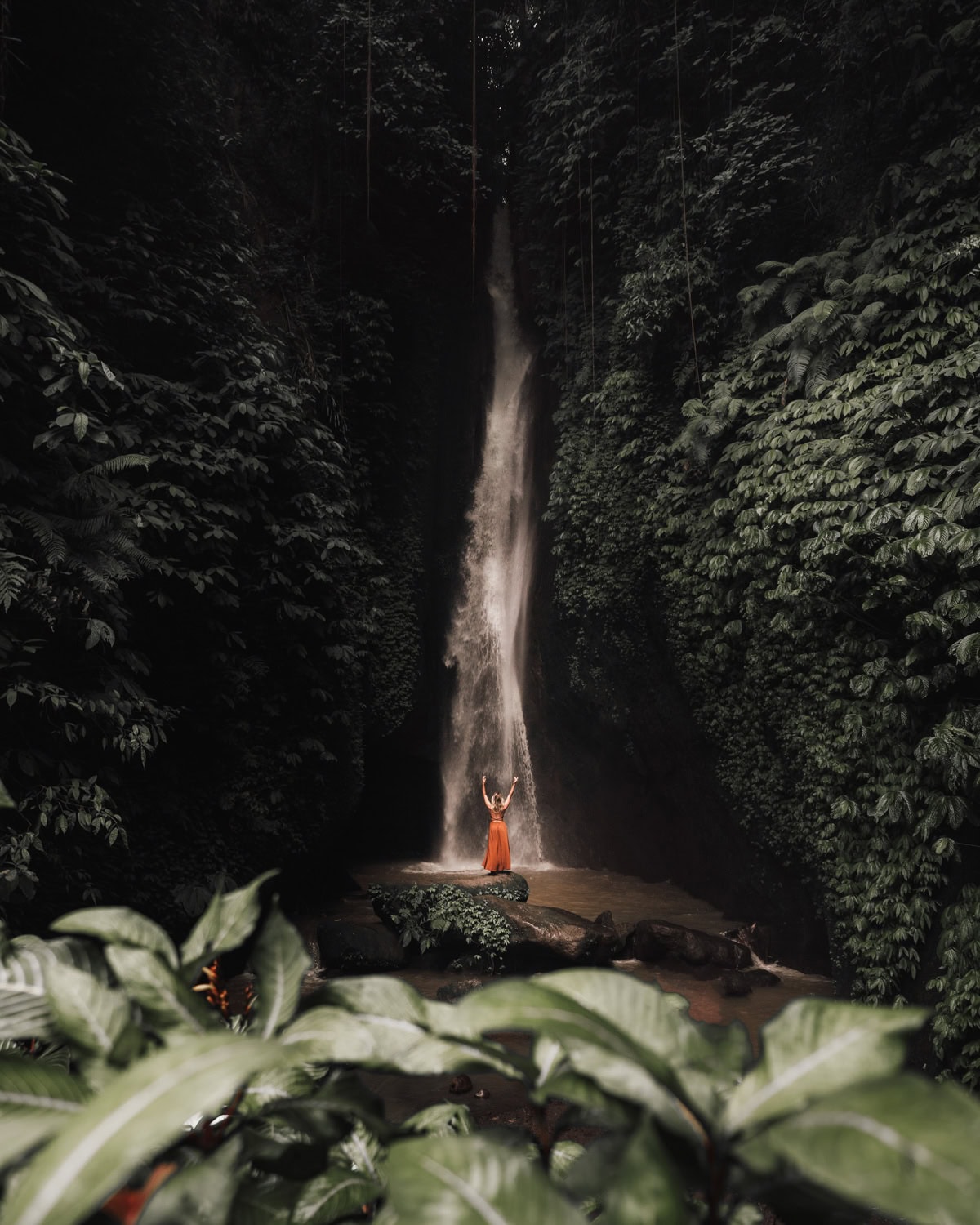 leke-leke waterfall with a woman standing