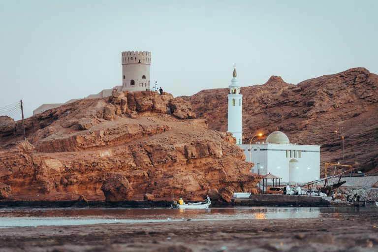 Watch tower and mosque in Sur, Oman during a sunset