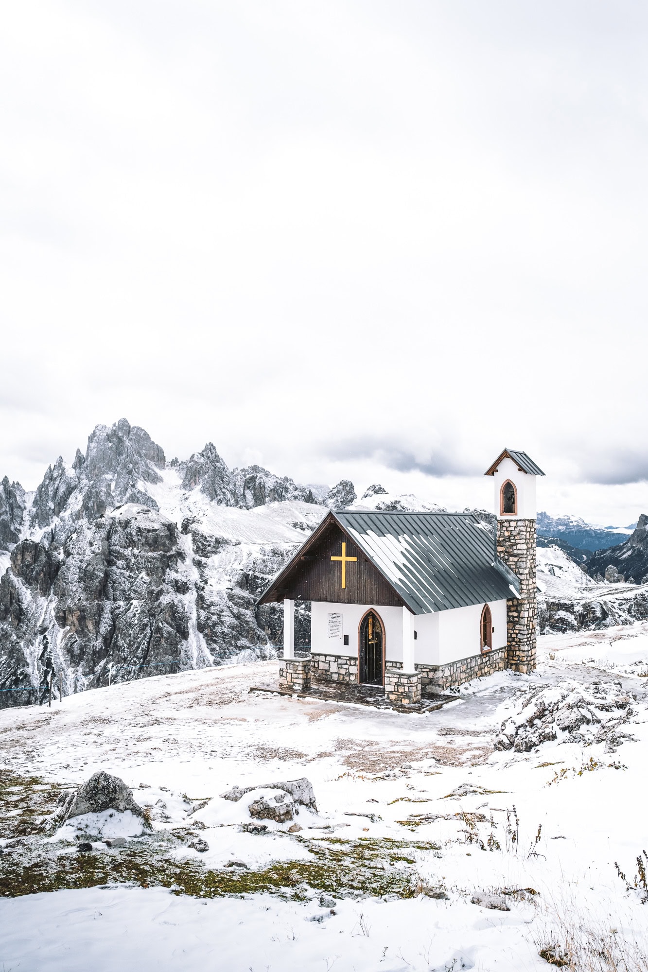 Church capped in snow around Tre Cime in Dolomites