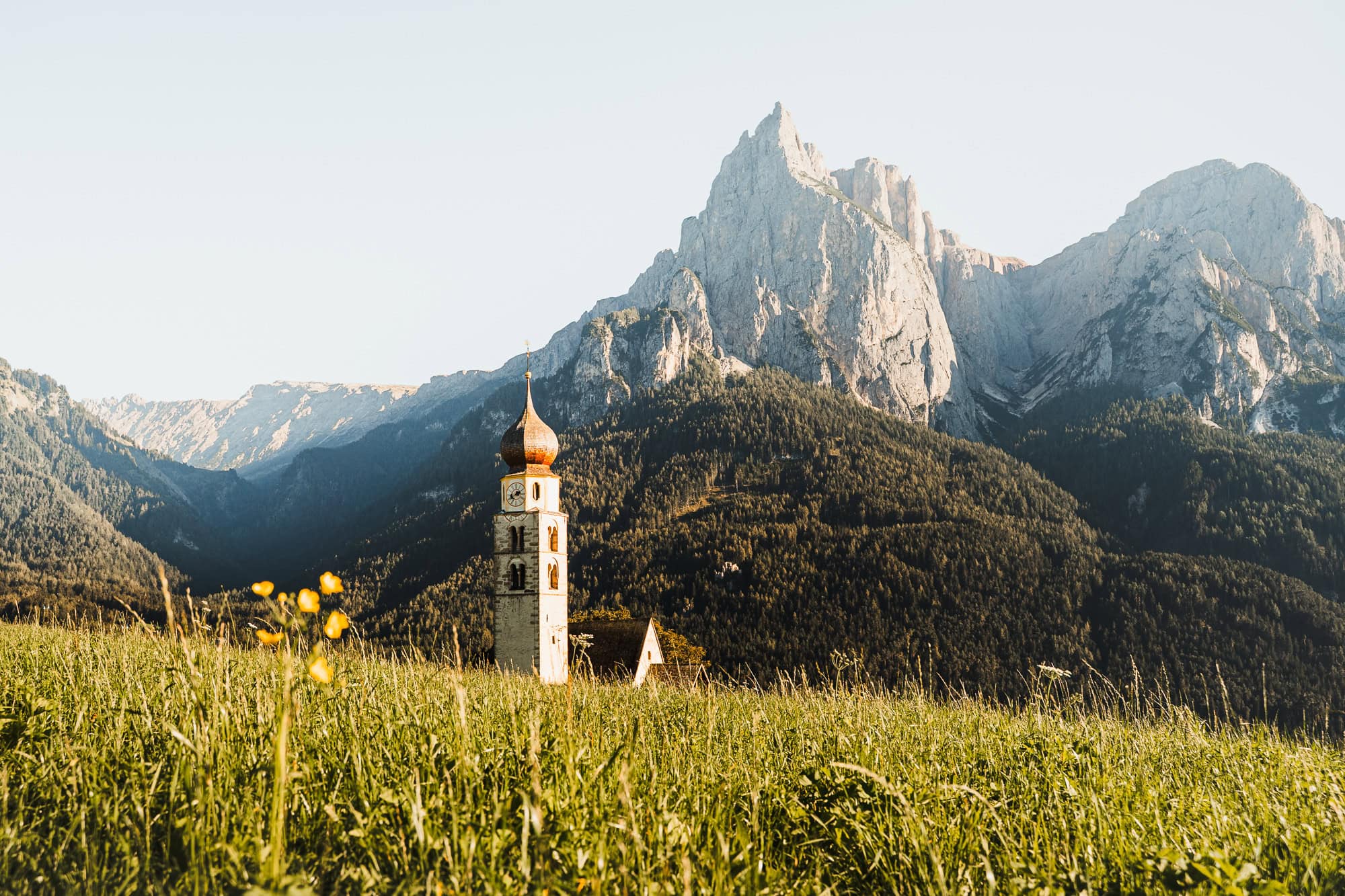 Church in front of mountain range in Dolomites, Italy