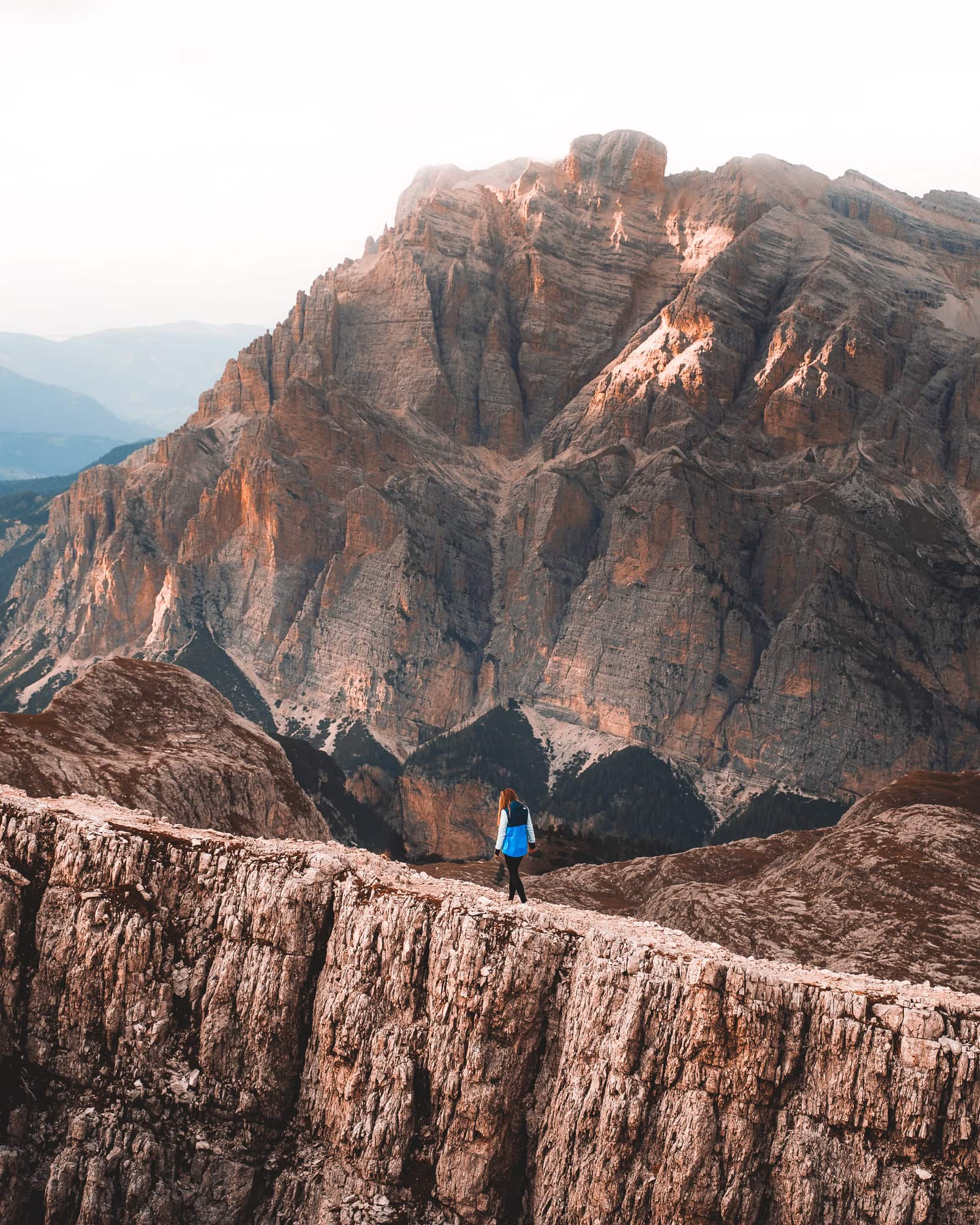 Girl walking on a mountain ridge in the Dolomites, Italy