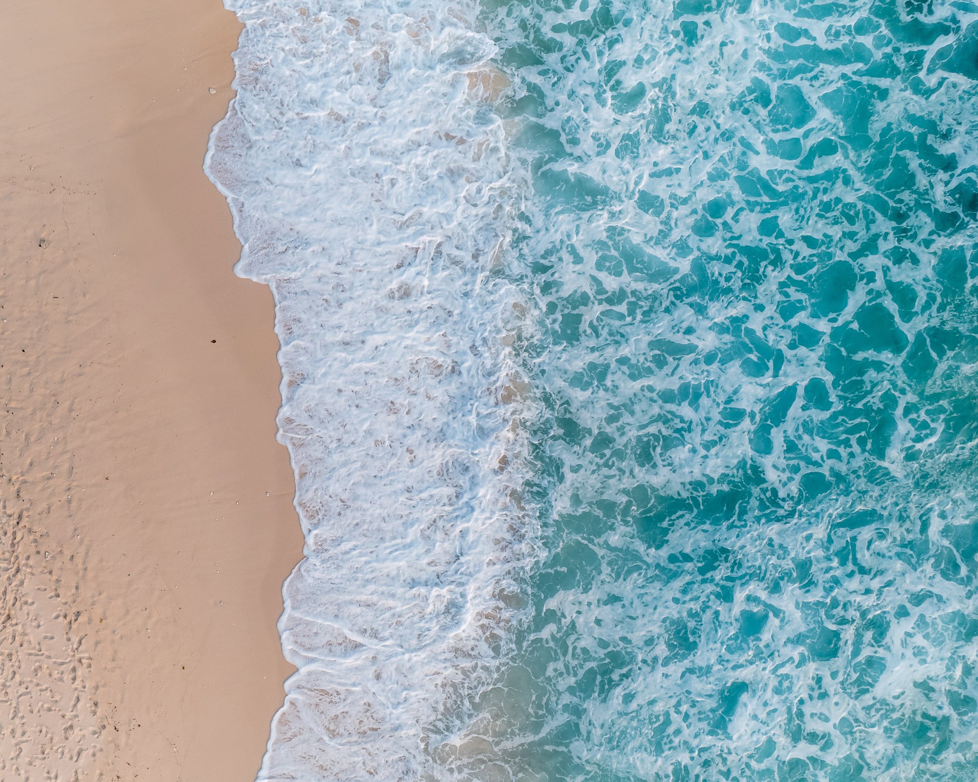Top down of a beach, blue water