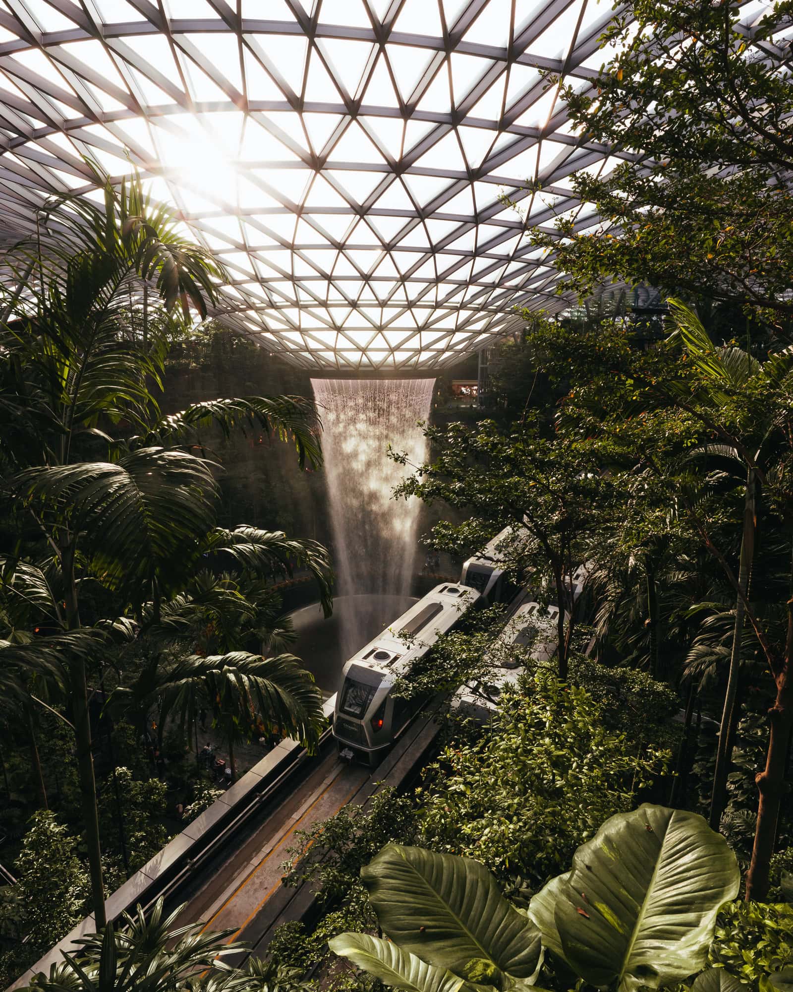 Train in front of waterfall in an airport in Singapore