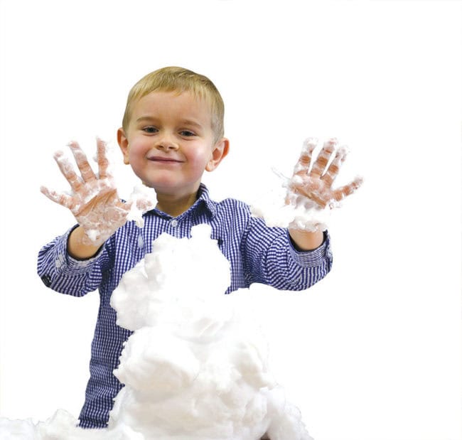 Un enfant jouant avec la mousse sensorielle Schaumi, explorant sa texture douce et malléable