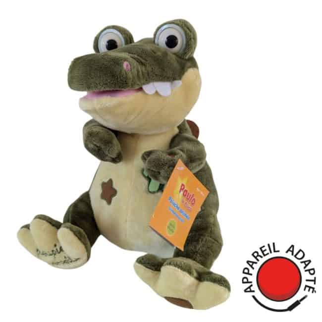 Peluche crocodile animée Paulo, jouet interactif adapté pour contacteur, offrant des moments de jeu inclusifs pour les enfants et adultes à besoins spécifiques
