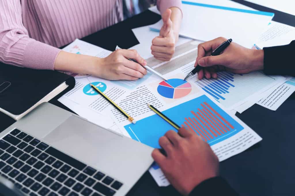 Business professionals analyzing financial charts and reports at PG Accounting LTD.