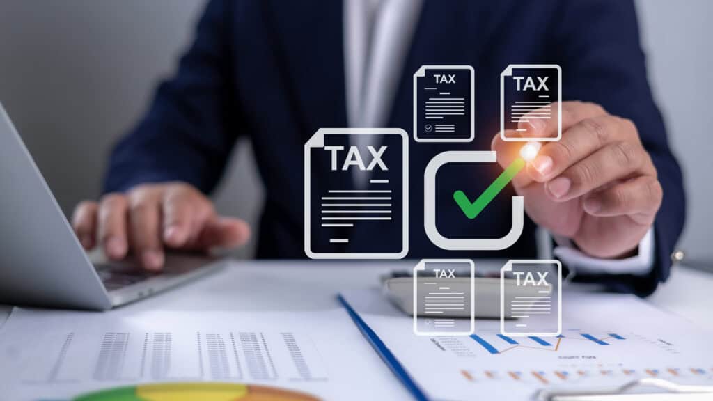 Tax documents and digital checkmark representing professional tax and accounting services.