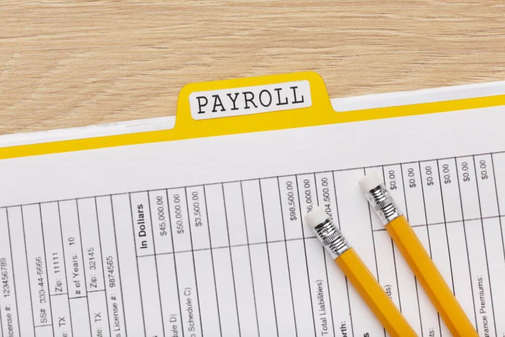 Payroll document with pencils, representing payroll management and accounting services at PG Account.