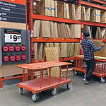 Durable orange industrial carts with wheels at P&H Casters store.