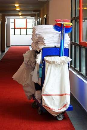 Cleaning Cart with Supplies in Hallway