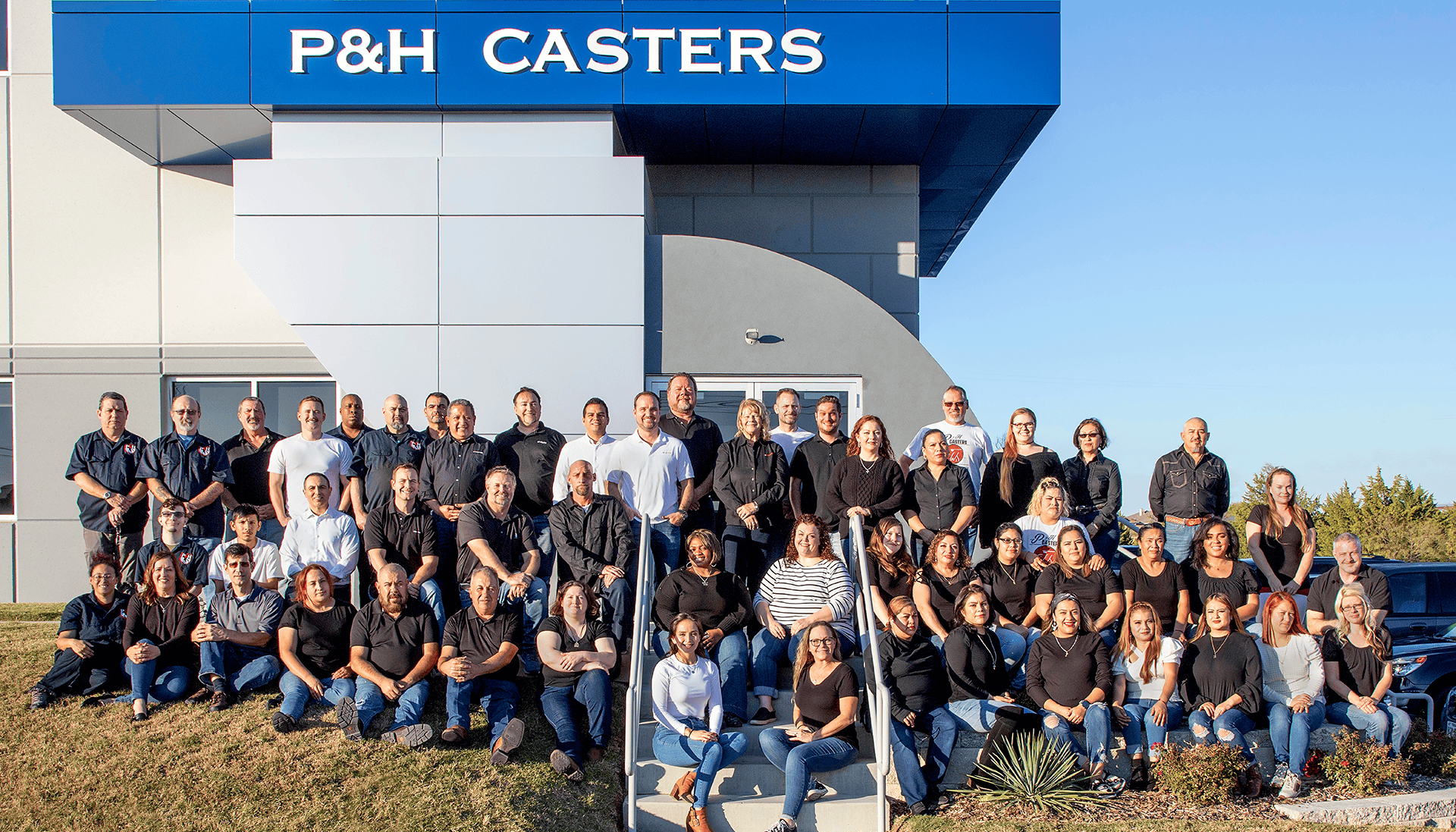 P&H Casters team photo outside company building, showcasing staff and leadership.