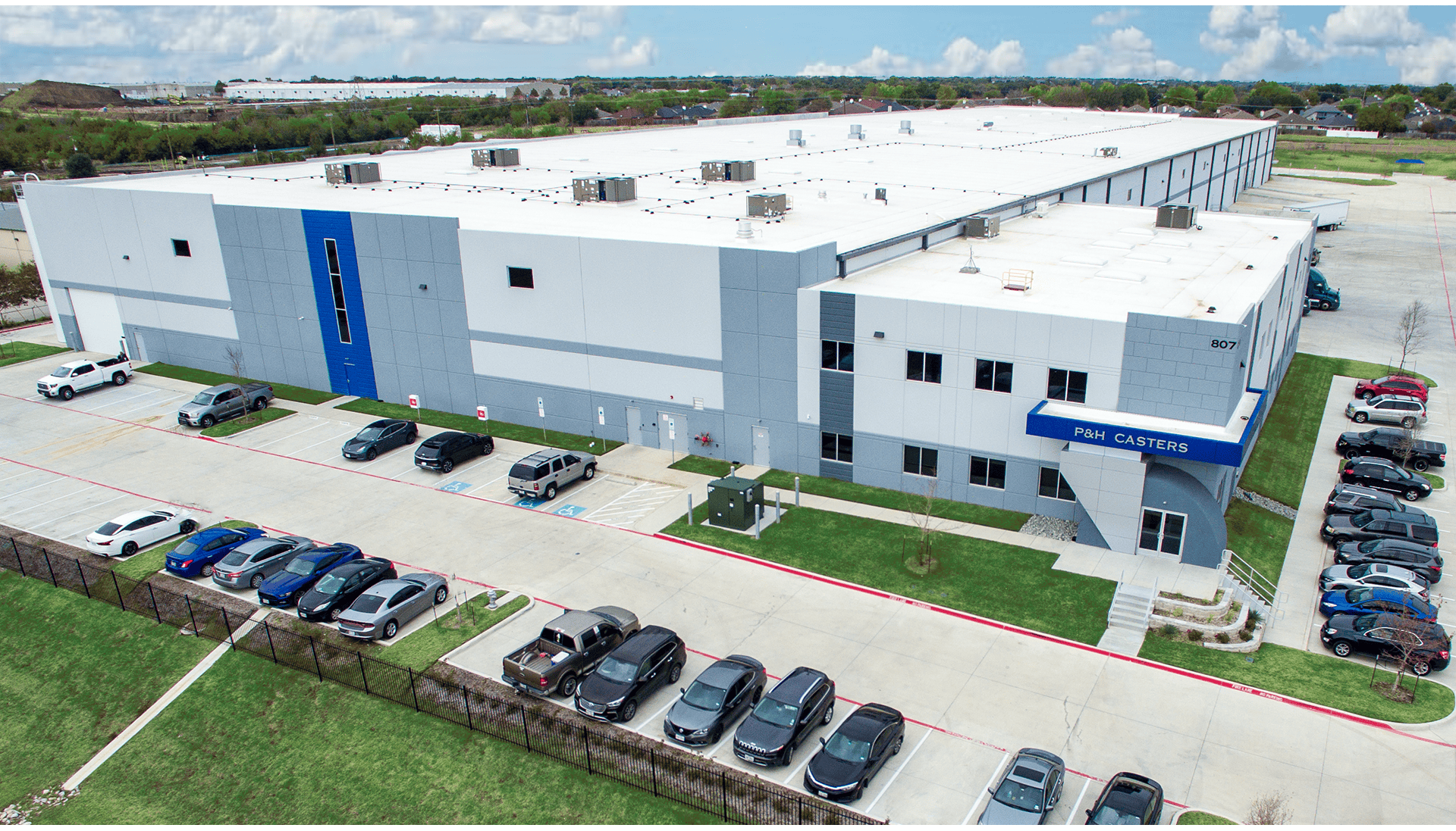 Modern P&H Casters manufacturing plant with ample parking and clean exterior.