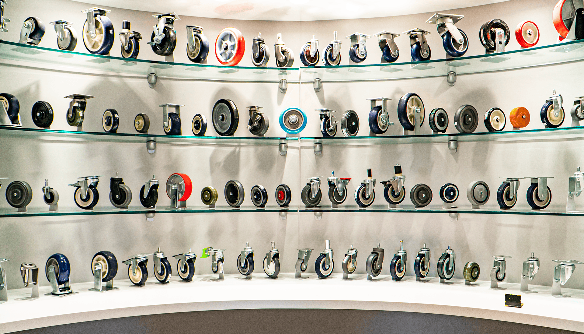 Wide display of various industrial caster wheels at P&H Casters showroom.