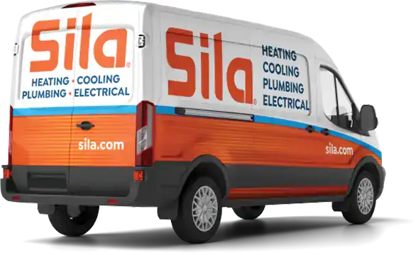 A Sila service van with branding and text for heating, cooling, plumbing, and electrical services is parked, displaying the company website sila.com.