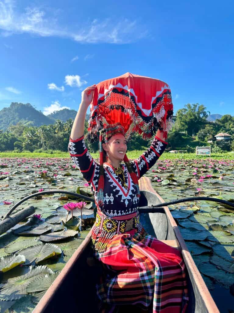 Rachel Bomogao Obo-ob at Lake Sebu, surrounded by lotus flowers