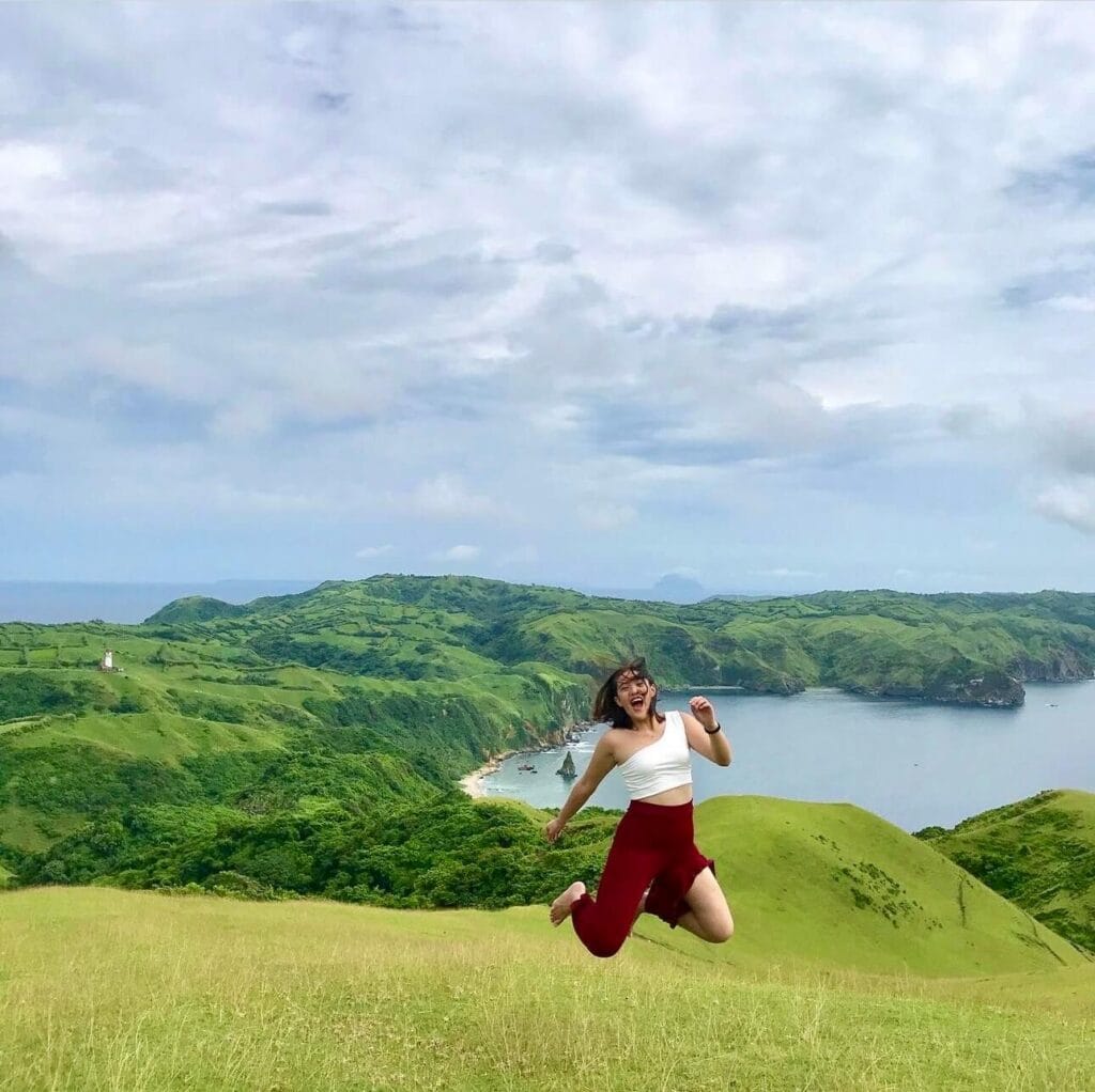 Rachel Bomogao Obo-ob overlooking the rolling hills and coastline of Batanes