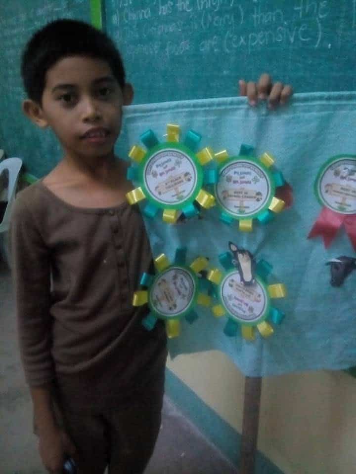Young Jaja showing her awards