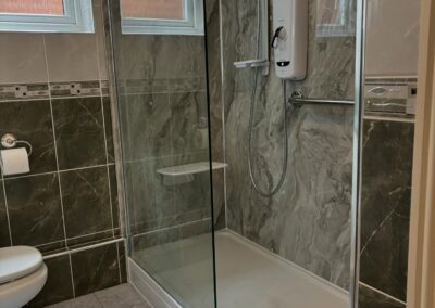 Modern bathroom with glass shower and marble tiles
