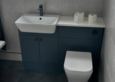 Modern bathroom with sink, toilet, and toilet paper