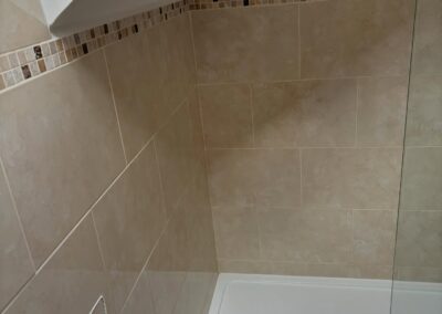 Modern tiled shower with glass panel