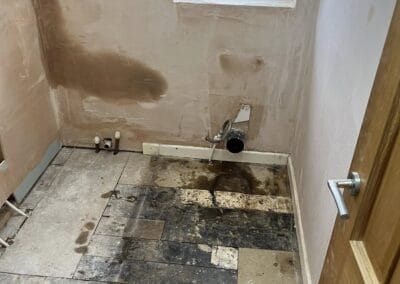 Bathroom under renovation with exposed floor and walls.