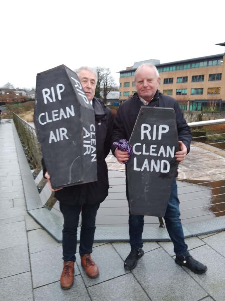 Save our Sperrins campaigners hold prop coffins to signifiy the damage and fear caused by proposals to carve out a gold mine in the mountain range.