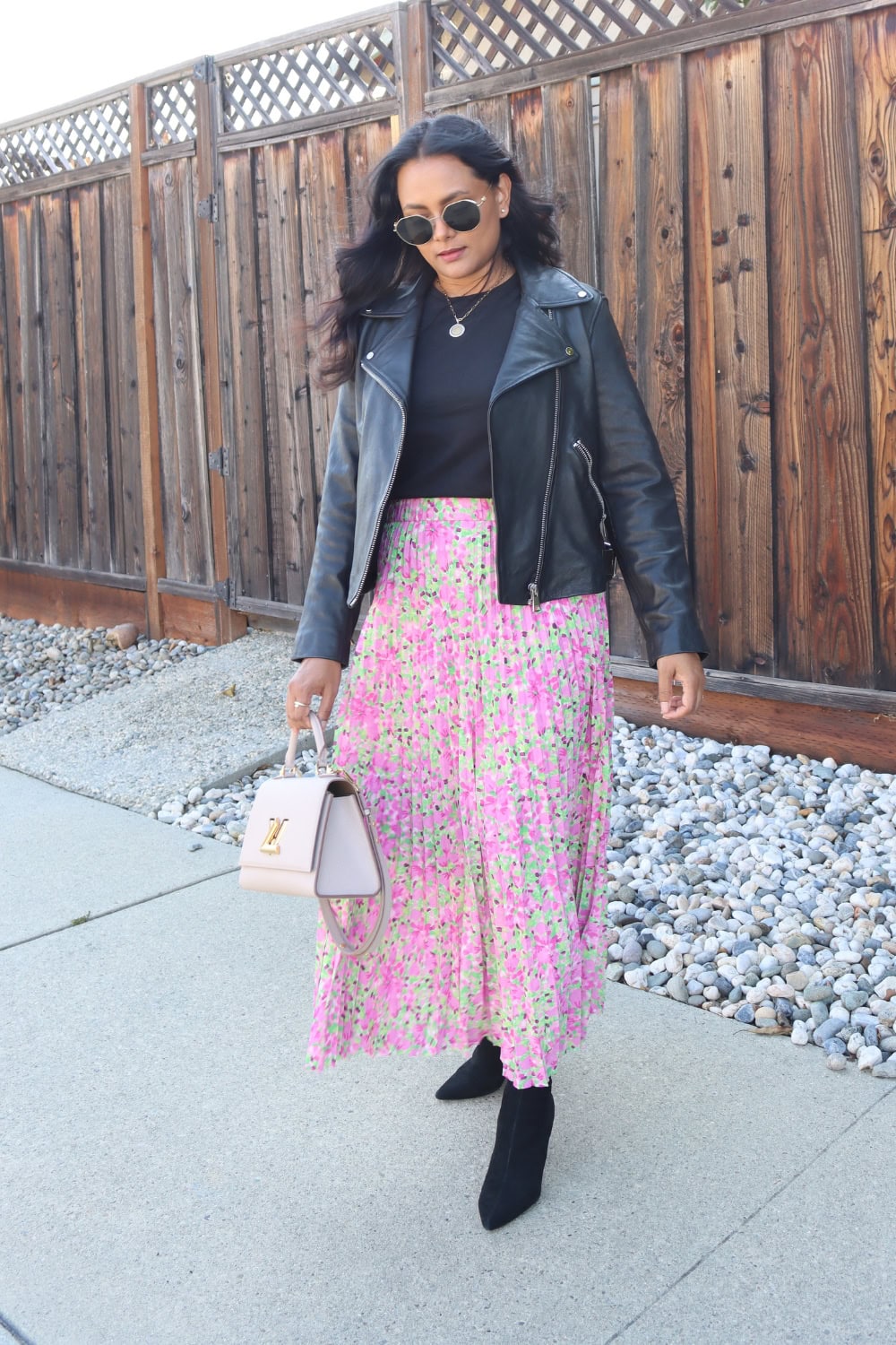 Pleated skirt outfit with black leather jacket