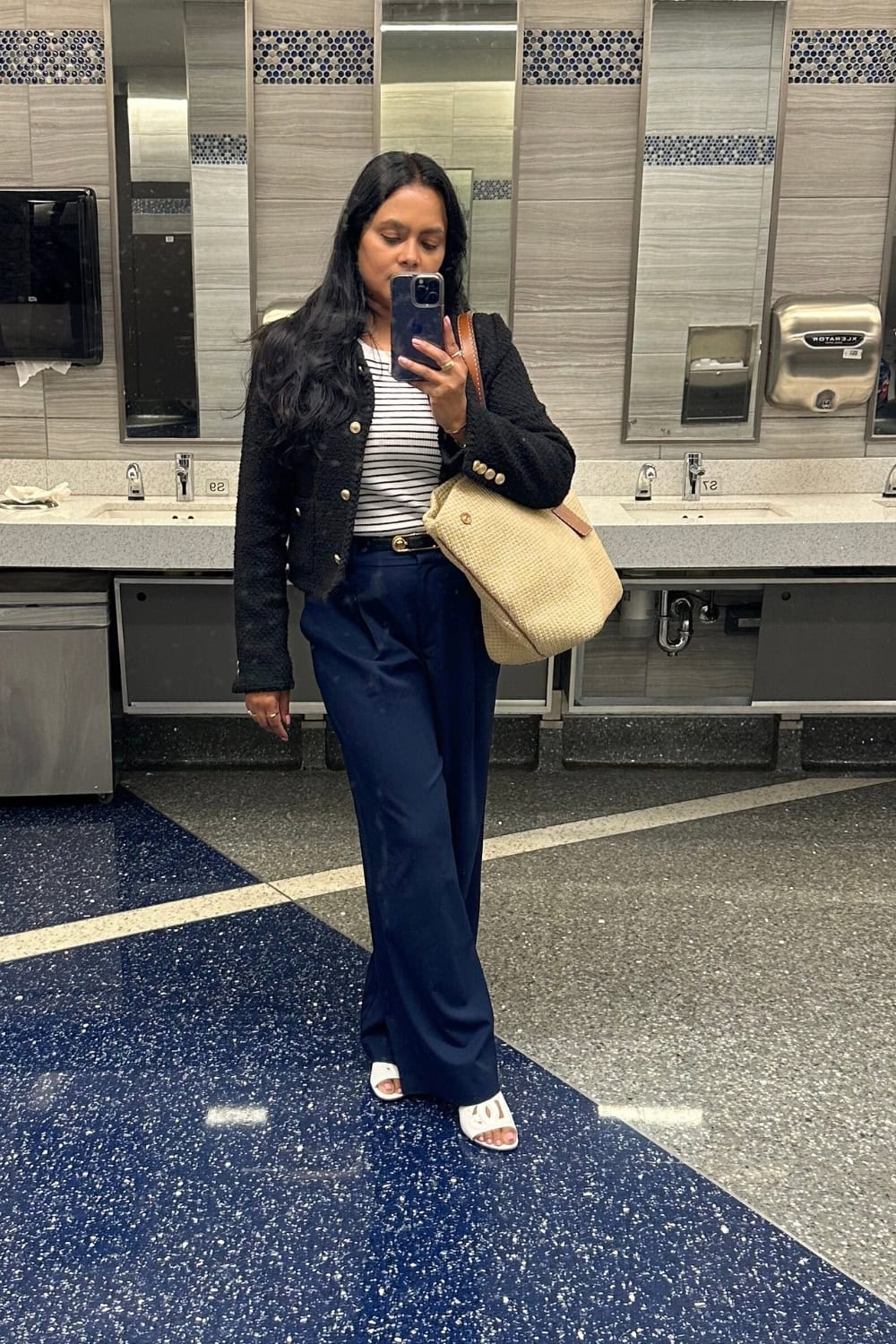 a woman taking a selfie in a bathroom