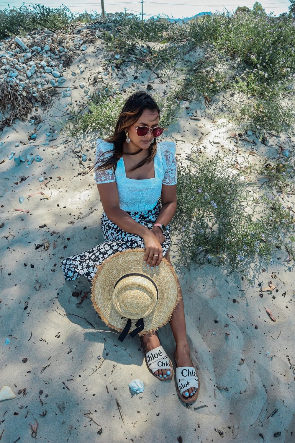 a woman sitting on the sand