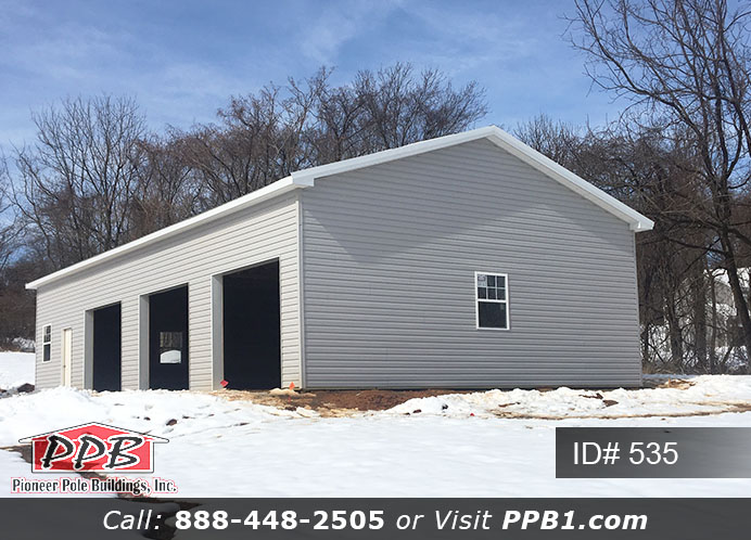 Pole Building Dimensions: 30’ W x 56’ L x 12’ 4” H (ID# 535) 30’ Standard Trusses, 4’ on Center 4/12 Pitch Colors: Siding Color: Sterling Gray (Vinyl Siding) Roofing Color: Black Trim Color: White & Black Openings: (3) 10’ x 8’ Residential Classic Garage Doors with (5) Windows & Hi-Lift (1) 3068 6-Panel Insulated Entry Door (3) 3’ x 4’ Single-Hung Insulated Windows with Screens & Grids
