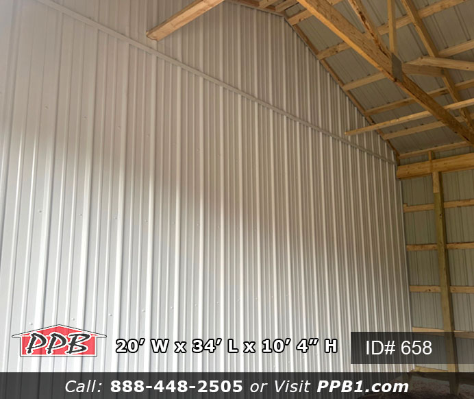 A white partition wall in a brown pole building.