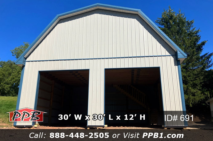 This is a thirty foot wide by thirty foot long ash gray gambrel barn with a twelve foot high ceiling height. This building has two ten foot wide by ten foot high garage doors on the front gable. There is one foot overhangs around the whole building. The metal roof color is heron blue with ocean blue trim. This barn has a set of stairs to the second floor to be used as extra storage or as a living space.