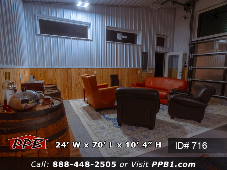 Siding area with a concrete floor and knotty pine up the wall four feet with metal liner panel the rest of the way up the wall.