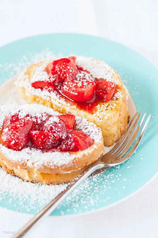 French toast with strawberries and powdered sugar, perfect for breakfast.