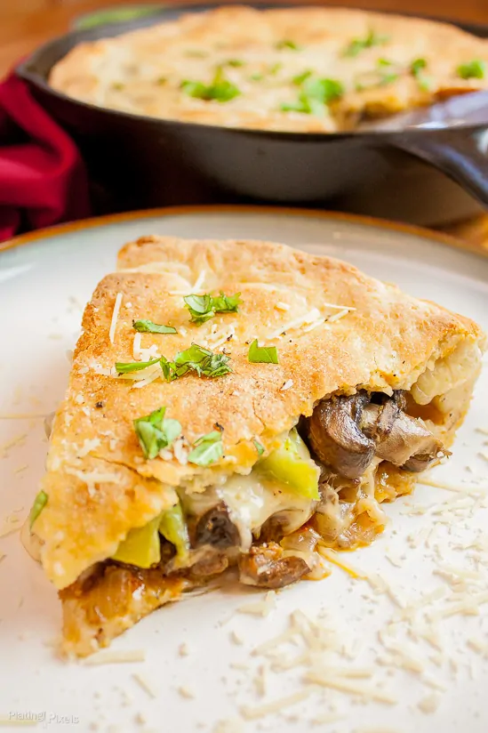 Delicious skillet calzone with mushrooms, cheese, and green onions, perfect for a hearty meal.