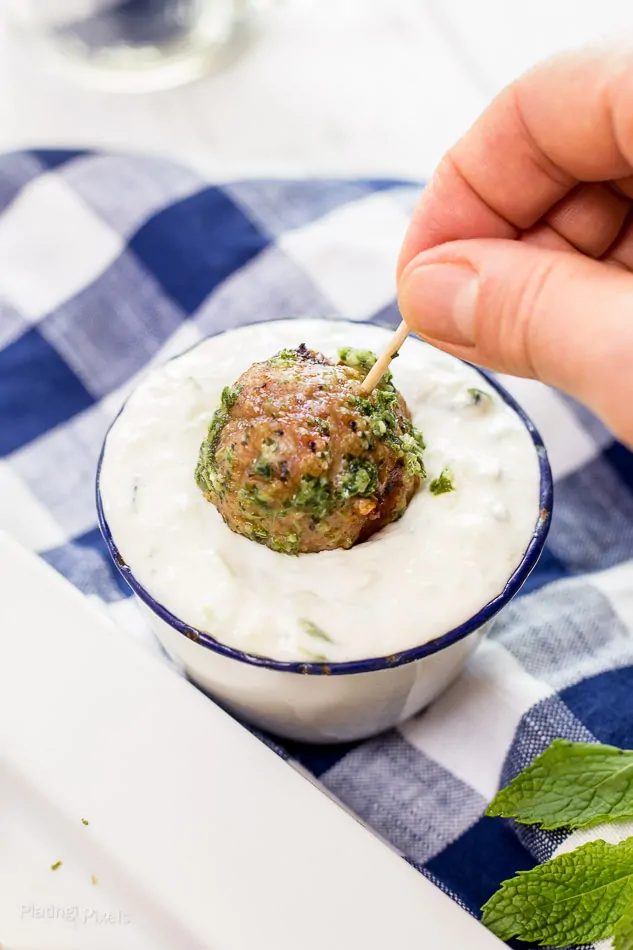 Turkey meatball with cucumber mint sauce for Greek-inspired dish.
