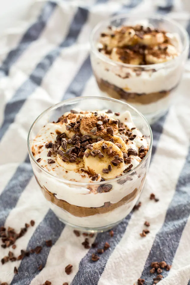Delicious gluten-free breakfast parfaits with chocolate, almond butter, and banana slices.